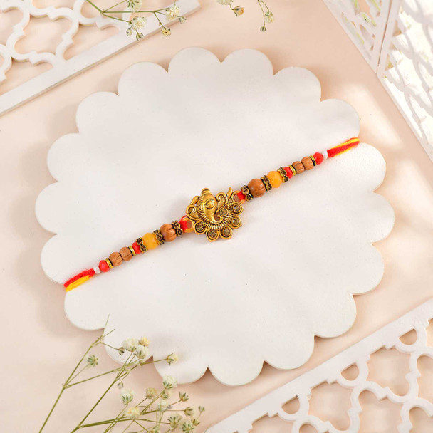 Golden Ganesha Rakhi With Kaju Katli