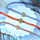 Set Of Three Traditional Rakhi With Besan Laddu & Toblerone Chocolates
