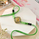 Designer Green Golden Rakhi With Snickers Chocolates