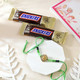 Designer Green Golden Rakhi With Snickers Chocolates