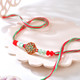 Elegant Floral Stone Rakhi with Red & Mint Green Beads