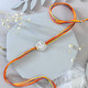 The Khanda Sahib Silver Rakhi with Kaju Katli
