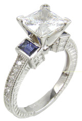 Trevora 1.5 carat princess cut lab grown diamond quality cubic zirconia emerald cut man made sapphire engagement ring in 14k white gold.