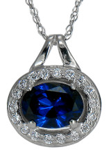 The Serefine Man Made Sapphire 1 Carat 8x6mm Oval Halo Pave Set Round Pendant with simulated lab grown diamond quality cubic zirconia in 14k white gold.