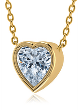 Heart shape bezel set lab created diamond alternative cubic zirconia solitaire pendant in 18k yellow gold.