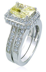 Elegant 2.5 carat emerald cut canary lab grown diamond simulant cubic zirconia pave set halo cathedral wedding set in 14k white gold.