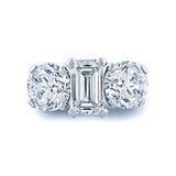 Joella emerald cut and round laboratory grown diamond alternative cubic zirconia three stone ring in platinum.