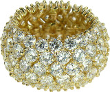 Flexible prong set round flexible laboratory grown diamond look cubic zirconia eternity wedding band in 14k yellow gold.