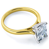 Radiant Emerald cut lab grown diamond look alternative cubic zirconia cathedral solitaire engagement ring in 14k yellow gold with white gold prongs.