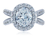 Oval 2.5 carat lab created cubic zirconia pave halo engagement ring in 18k white gold.