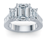 Emerald cut 2.5 carat three stone channel set princess cut cathedral engagement ring in 14k white gold.