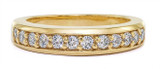 Kirkman anniversary band lab grown diamond simulant cubic zirconia shared prong set pave in 18k yellow gold.