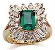 Emerald cut 2.5 carat laboratory grown diamond alternative cubic zirconia round and baguette halo cluster ballerina ring in 14k yellow gold.