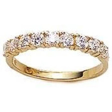 Prong set round lab grown diamond alternative cubic zirconia anniversary band in 14k yellow gold.