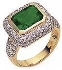 Emine 4 carat horizontal emerald cut bezel ring with a halo of pave round lab grown diamond simulant cubic zirconia in 14k yellow gold.