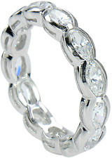 Horizontal set oval laboratory grown diamond look cubic zirconia semi bezel set eternity band in 14k white gold.