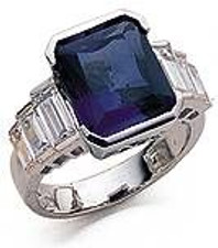 Lab created sapphire 4 carat emerald cut engagement ring with graduated cubic zirconia baguettes in 14k white gold.