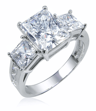 Romero 2.5 carat emerald cut and .75 carat princess cut lab grown diamond simulant cubic zirconia three stone ring in 14k white gold.