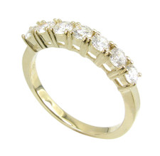 Basket prong set round lab grown diamond simulant cubic zirconia diamond quality anniversary band in 14k yellow gold.