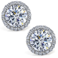 Stunner 3 carat round lab grown diamond quality cubic zirconia micro pave halo stud earrings in 14k white gold. Stunner 3 carat round lab grown diamond quality cubic zirconia micro pave halo stud earrings in 14k white gold.