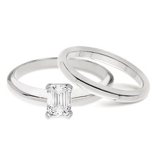 Emerald cut lab created cubic zirconia classic solitaire engagement ring with matching wedding band in 14k white gold.