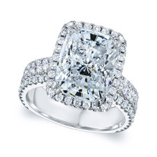 Emerald cut 9 carat halo lab grown diamond simulant cubic zirconia three stone engagement ring in 14K white gold.