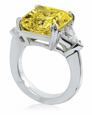 Princess cut 8.5 carat canary yellow with diamond look trillion lab grown cubic zirconia side stones in 14k white gold.