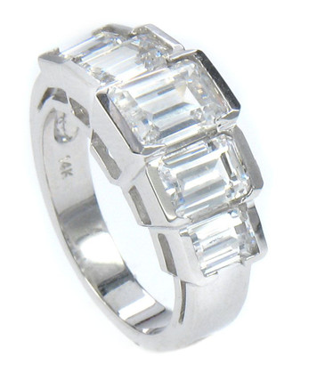 Emerald step cut laboratory grown diamond alternative cubic zirconia graduated semi bezel set band in 14k white gold.