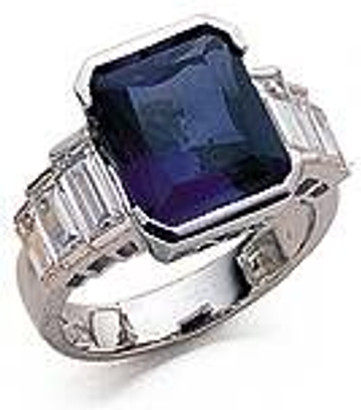 Man made sapphire 4 carat emerald cut engagement ring with graduated lab grown diamond alternative cubic zirconia baguettes in 14k white gold.