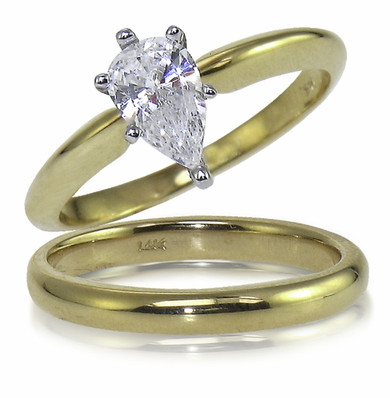 Pear shape lab grown diamond look cubic zirconia classic solitaire engagement ring with matching wedding band in 14k yellow gold.