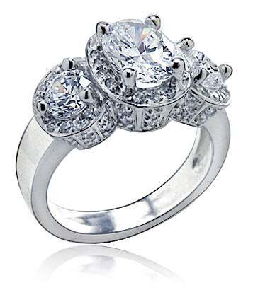 Vanessa 1.5 carat oval lab created cubic zirconia pave halo three stone ring in 14k white gold.