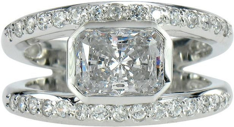 Karand 1.5 carat bezel set emerald radiant cut lab grown diamond simulant cubic zirconia split shank engagement ring in platinum.