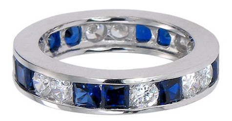 Man made princess cut sapphire and lab grown diamond alternative cubic zirconia round alternating channel set eternity band in 14k white gold.