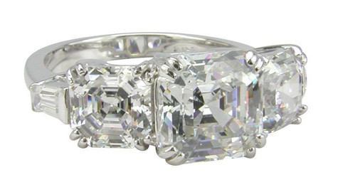 Asscher cut 2.5 carat lab grown diamond alternative cubic zirconia three stone engagement ring with baguette accents in platinum.