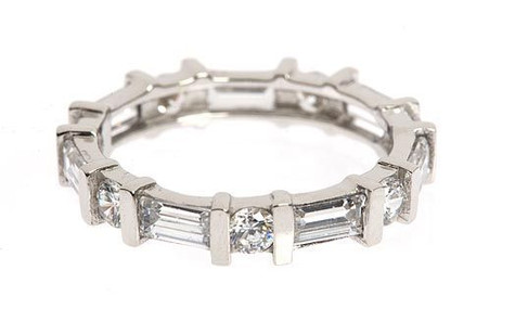 Baguette and round lab grown diamond alternative cubic zirconia channel set bar set eternity band in platinum.