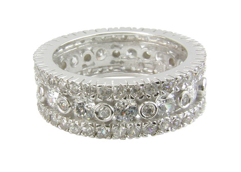 Round bezel, prong and pave set lab grown diamond look cubic zirconia eternity band in platinum.