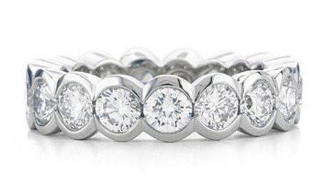 Semi bezel set round lab created cubic zirconia eternity band in 14k white gold, 14k yellow gold and platinum.