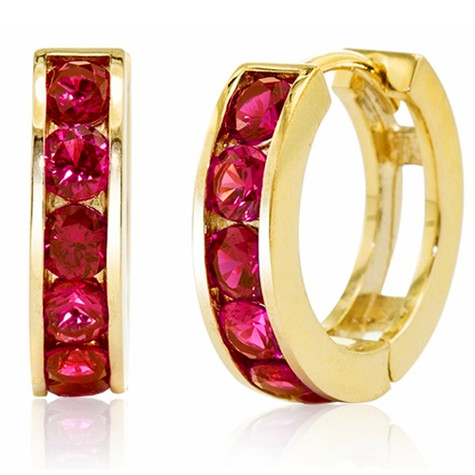 Channel set round simulated ruby red mini huggie hoop earrings in 14k yellow gold.