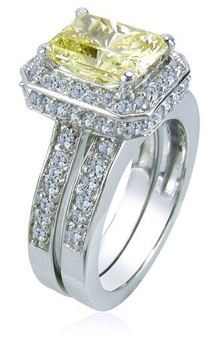 Elegant 1.5 carat emerald cut canary lab grown diamond look cubic zirconia zirconia pave set halo cathedral wedding set in 14k white gold.