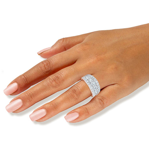 Woman wearing the Trifectia three row round prong set lab grown diamond look cubic zirconia anniversary band in platinum.