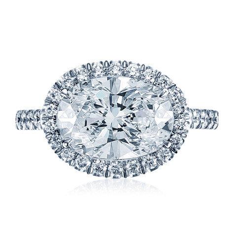 Horizontal oval halo pave ring with lab created diamond simulant cubic zirconia in 14k white gold.