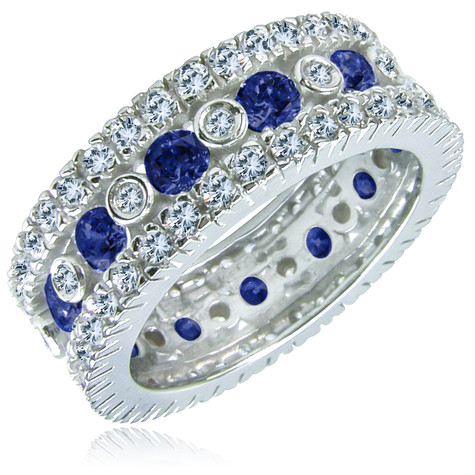 Round bezel, prong and pave set lab grown diamond look cubic zirconia eternity band in 14k white gold with lab created synthetic blue sapphires.