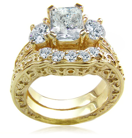 Emerald Cut 1.5 Carat and Round Three Stone Engraved Solitaire and Contoured Band with diamond lab grown diamond look cubic zirconia in 14k yellow gold.