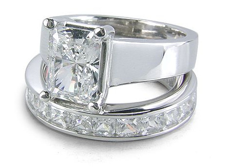 Radiant Emerald Cut Trellis Solitaire and Channel Set Princess Cut Eternity Band with simulated lab grown cubic zirconia in platinum.