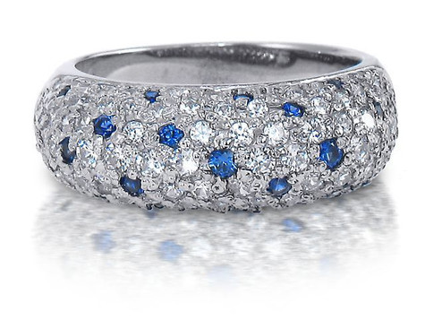 Pave set round man made sapphire and lab grown diamond look cubic zirconia anniversary band in platinum.