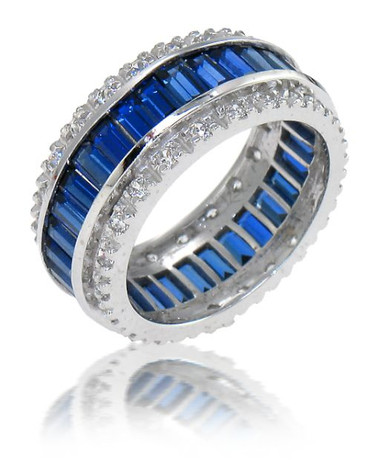 Channel set man made sapphire baguette and round eternity wedding band with lab grown diamond quality cubic zirconia in 14k white gold.