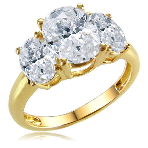 Oval 1.5 carat lab grown diamond simulant cubic zirconia three stone anniversary ring in solid 14k yellow gold.