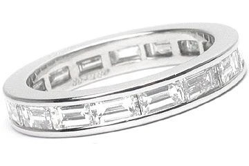 Horizontal channel set lab grown diamond quality cubic zirconia straight baguette eternity band in 14k white gold.