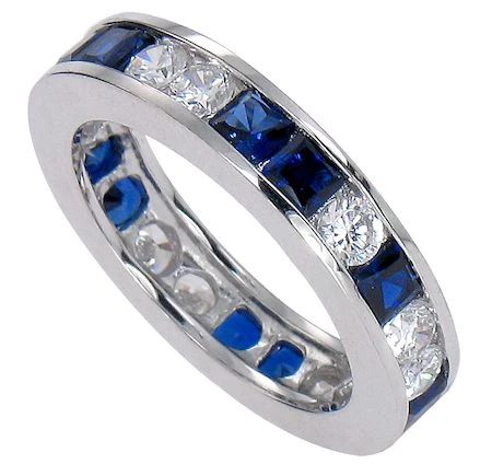 Man made princess cut sapphire and lab grown diamond simulant cubic zirconia round alternating channel set eternity band in platinum.