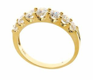 Electra graduated round lab grown diamond quality cubic zirconia prong set anniversary band in 14k yellow gold.